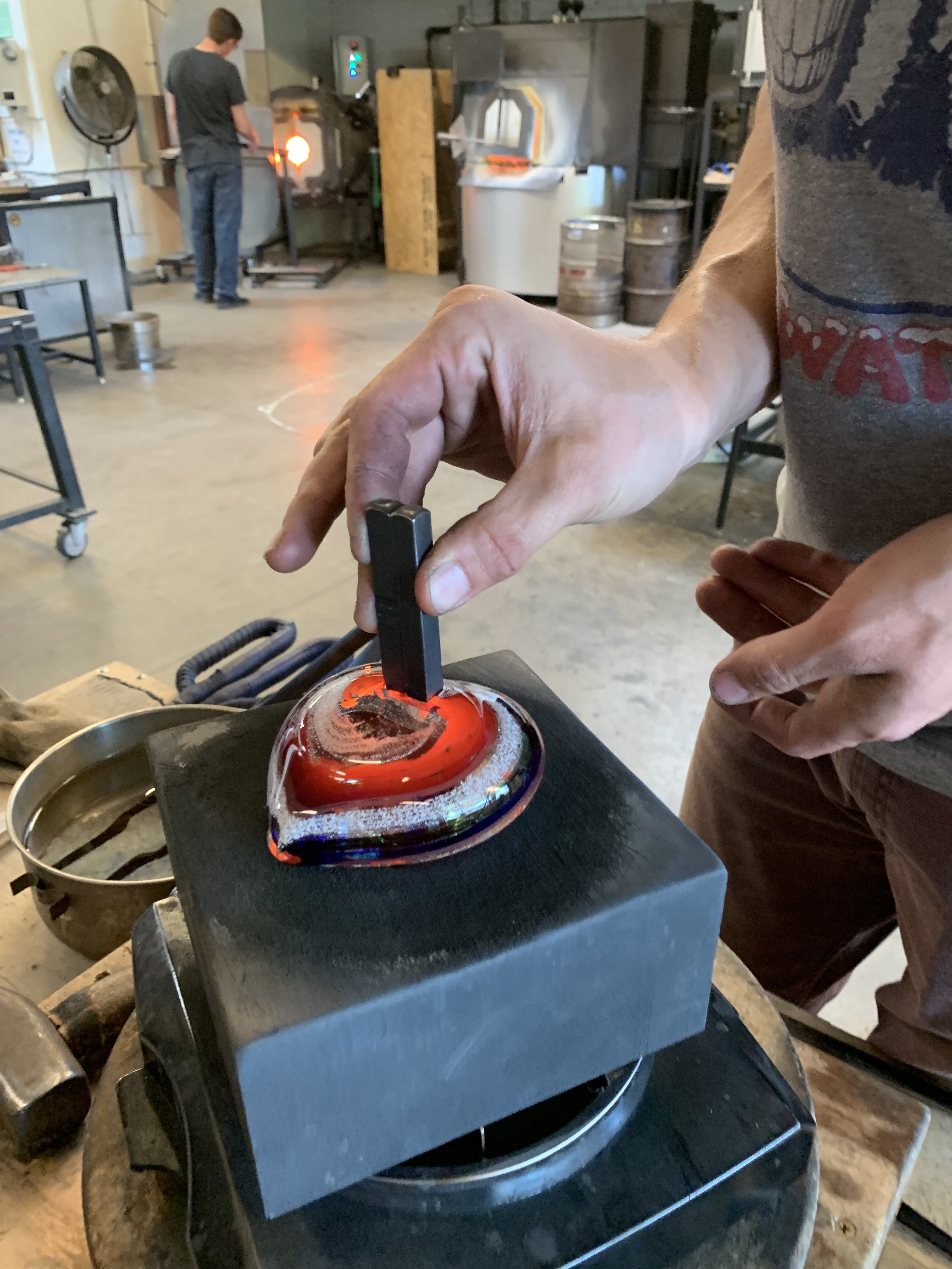 A person is using a knife to cut glass.