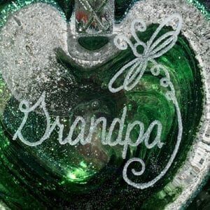 A green heart with the word " grandpa " written on it.