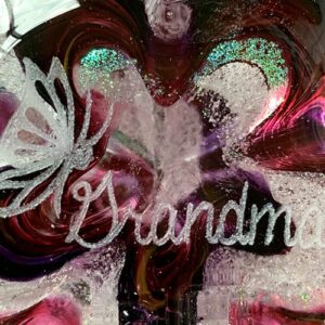 A close up of the word grandma on a glass