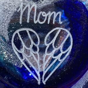 A glass bowl with the word mom written on it.