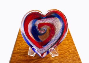 A heart shaped glass dish on top of a table.