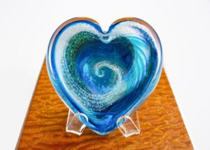 A heart shaped glass dish on display.