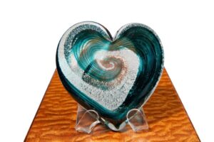 A heart shaped glass sculpture on display.