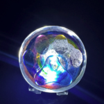 A glass ball with a colorful light inside of it.