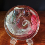 A glass plate with some red and white swirls